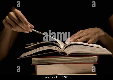 Hands turning book page Stock Photo