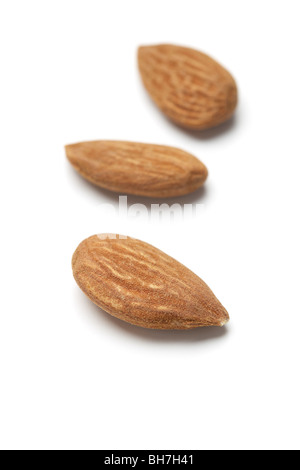 Three almond nut kernals on a white background Stock Photo