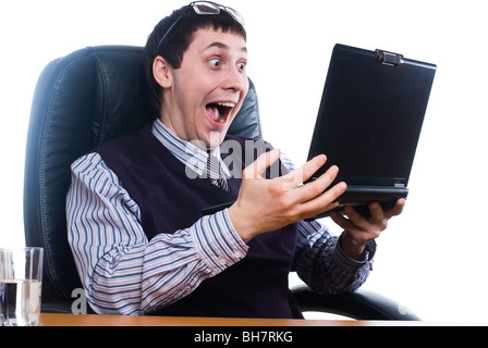 Young shocking businessman reading message on laptop Stock Photo