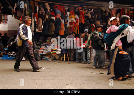 Ecuador, Otavalo, view of clothes market with people walking on street in the foreground, shopping Stock Photo