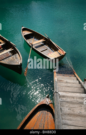 Steps down to wooden boats floating on water, Braies Lake, South Tyrol, Italy Stock Photo