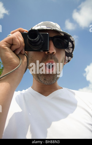 A man taking a photo with a digital camera Stock Photo
