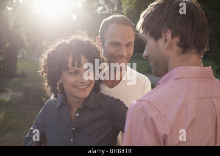 A man chatting with two friends Stock Photo