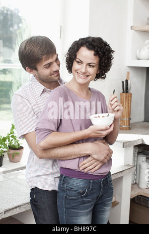 A couple embracing in the kitchen Stock Photo
