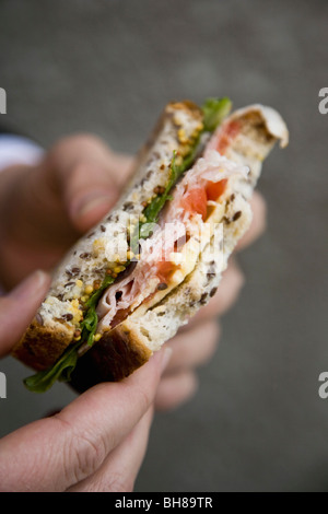 Detail of a person holding a sandwich Stock Photo