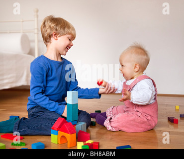 boy and baby with toy building blocks Stock Photo