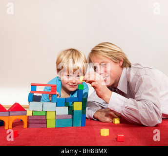 father and son play with building blocks Stock Photo