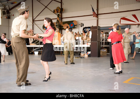 World War II actors dance in airport hanger at Mid-Atlantic Air Museum World War II Weekend and Reenactment in Reading, PA Stock Photo