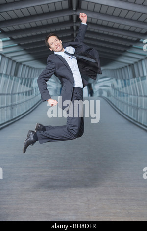 businessman jumping into air Stock Photo