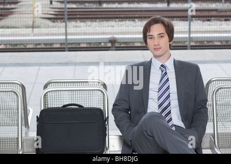 businessman sitting on bench, waiting Stock Photo