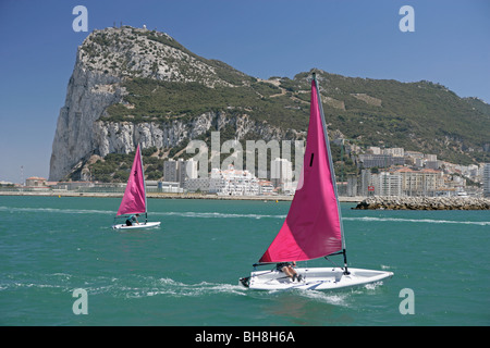 A dinghy sailboat race taking place in the bay below Gibraltar, England's tiny outpost possession in the Mediterranean. Stock Photo