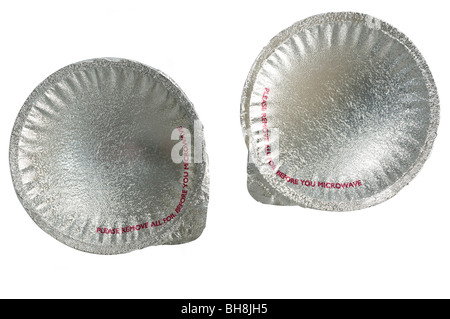 Two silver foil seals on two tubs of microwavable food products Stock Photo