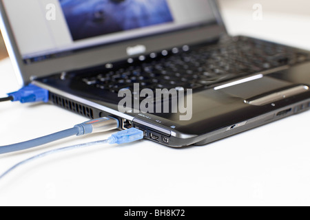 Cables plugged in to a Laptop computer. Stock Photo
