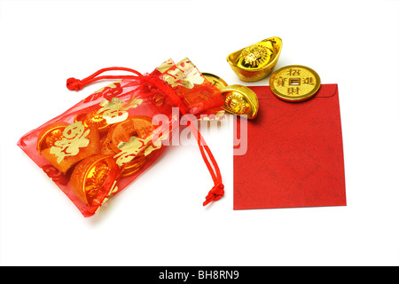 Chinese new year gold ingots and coins in red sachet and red packet on white background Stock Photo