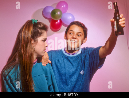 teen drink alcohol drug peer pressure offer tempt boy girl party refuse Stock Photo