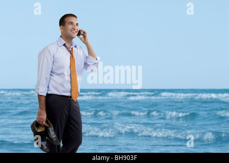 Businessman talking on the beach Stock Photo