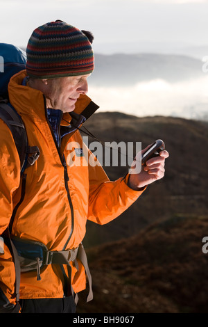 Hiker with GPS unit Stock Photo