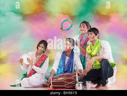 Friends playing music during holi Stock Photo