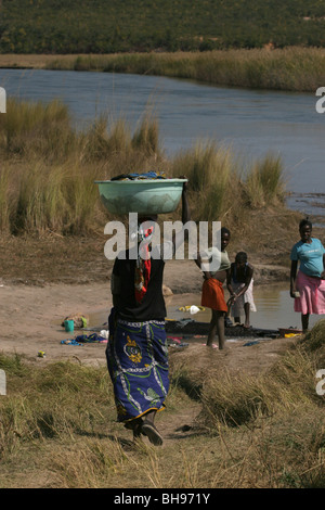 Women wash clothing in the Cuito river, Cuito Cuanavale, Angola, Africa Stock Photo