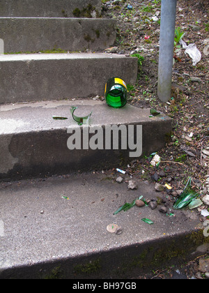Broken wine bottle on concrete steps Stock Photo