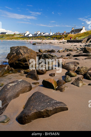 Port Logan in the Rhins of Galloway in Dumfries and Galloway in south west Scotland with the rocky beach in foreground Stock Photo