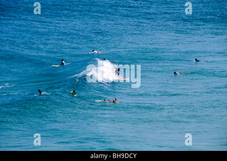 NORTH STRADBROKE ISLAND, Australia - A group of surfers waits for waves at Point Lookout on Stradbroke Island, Queensland's most easterly point. North Stradbroke Island, just off Queensland's capital city of Brisbane, is the world's second largest sand island and, with its miles of sandy beaches, a popular summer holiday destination. Stock Photo