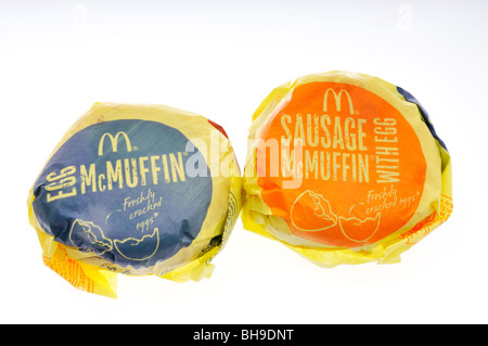 McDonald's Egg McMuffin and sausage McMuffin breakfast sandwiches in wrappers on white background. Cut out Stock Photo