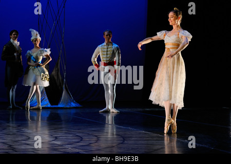 Cinderella dancing solo en pointe at the Ball while Prince Charming looks on in Ballet Jorgen stage production Stock Photo