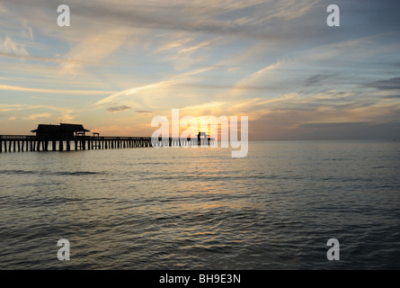 Sunset over the pier on Naples beach Naples Florida USA Stock Photo