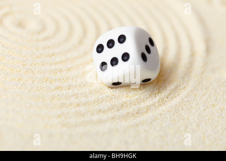 Abstract composition in the sand with white dice - Zen Garden Stock Photo