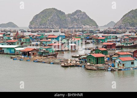 Floating Vietnamese village of Van Gia in Cat Ba Island bay, North Vietnam. Cat Ba Island is a National Park within Halong Bay. Stock Photo