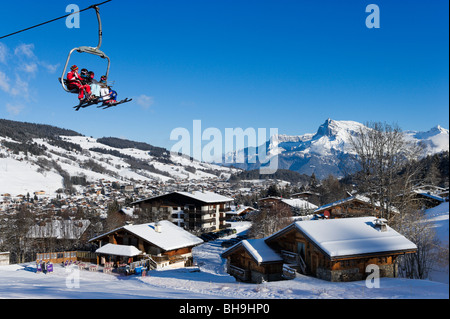 Chairlift and view over the resort from the slopes in the Rochebrune area, Megeve, Haute Savoie, France