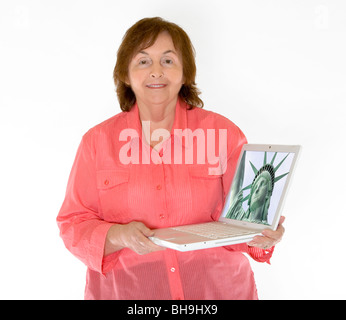 A senior retired elderly woman holds a laptop computer. Stock Photo