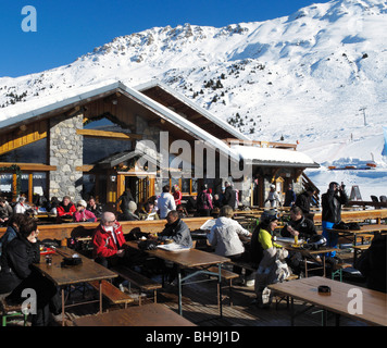 Skiers having lunch in a mountain restaurant in the Altiport ski area of Meribel, Three Valleys, Tarentaise, Savoie, France Stock Photo