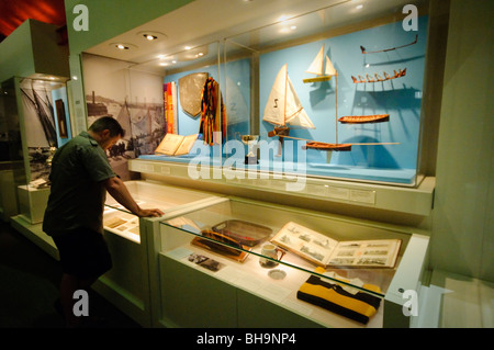 SYDNEY, Australia — Display cases in an exhibit of the Australian National Maritime Museum in Sydney. The Australian National Maritime Museum stands prominently along the waterfront of Darling Harbour. The museum's distinctive white roof and modern architecture contrast with the historic vessels moored alongside, including the replica of Captain Cook's HMB Endeavour. Stock Photo