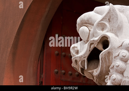 Statue of Traditional Chinese guard dog watching over the main entrance to a town in Yunnan, China. Stock Photo