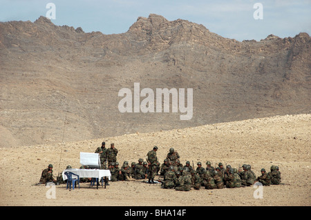 A group of Afghan National Army (ANA) recruits receiving basic training in an outdoor classroom setting in the mountains near Kabul, Afghanistan. Stock Photo