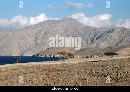 The Arabian Gulf and the mountains of the Musandam peninsula located on the south end of the Strait of Hormuz, in the Arabian Gulf, Sultanate of Oman. Stock Photo