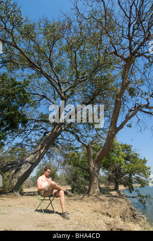 Tourists enjoy the multitude of views over the Zambezi River in Zimbabwe's Mana Pools National Park. Stock Photo