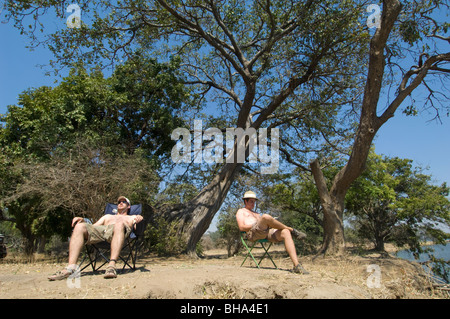 Tourists enjoy the multitude of views over the Zambezi River in Zimbabwe's Mana Pools National Park. Stock Photo