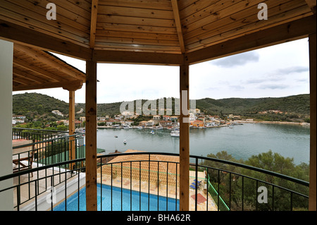 View from a holiday vacation villa balcony over the swimming pool towards the harbour of Valthi on Meganissi island, Lefkas Stock Photo