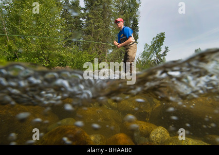 Underwater perspective of a fly fisherman fishing for rainbow trout in Montana Creek, Southcentral, Alaska Stock Photo
