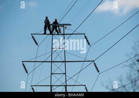 Men working on power lines. Stock Photo