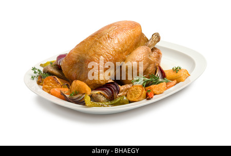 Roast chicken and vegetables on a carving platter. Stock Photo