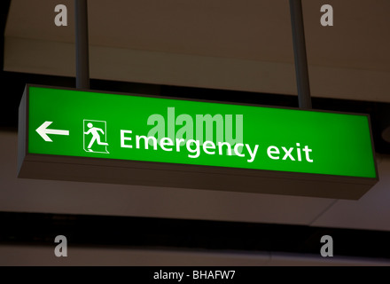 Emergency exit sign at airport, Terminal 5, Heathrow airport, London, England Stock Photo