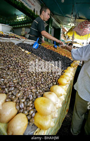 Olives for sale at a produce stall along one of the many narrow alleys at the casbah in Tetuon, Morocco Stock Photo