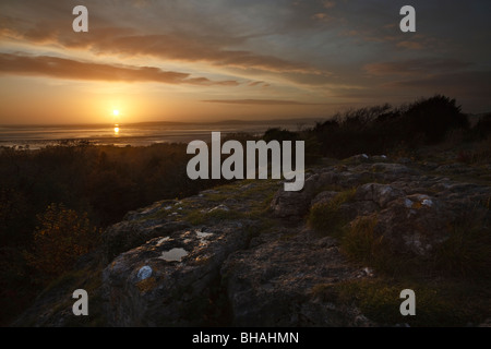 Sunset view across Morecambe Bay from Eaves Wood, Silverdale, Lancashire Stock Photo