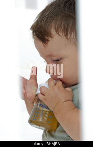 Baby boy drinking from bottle Stock Photo