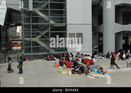 Filipino maids gather on a Sunday under the HSBC building in Hong Kong