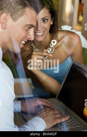 Couple sitting at laptop Stock Photo